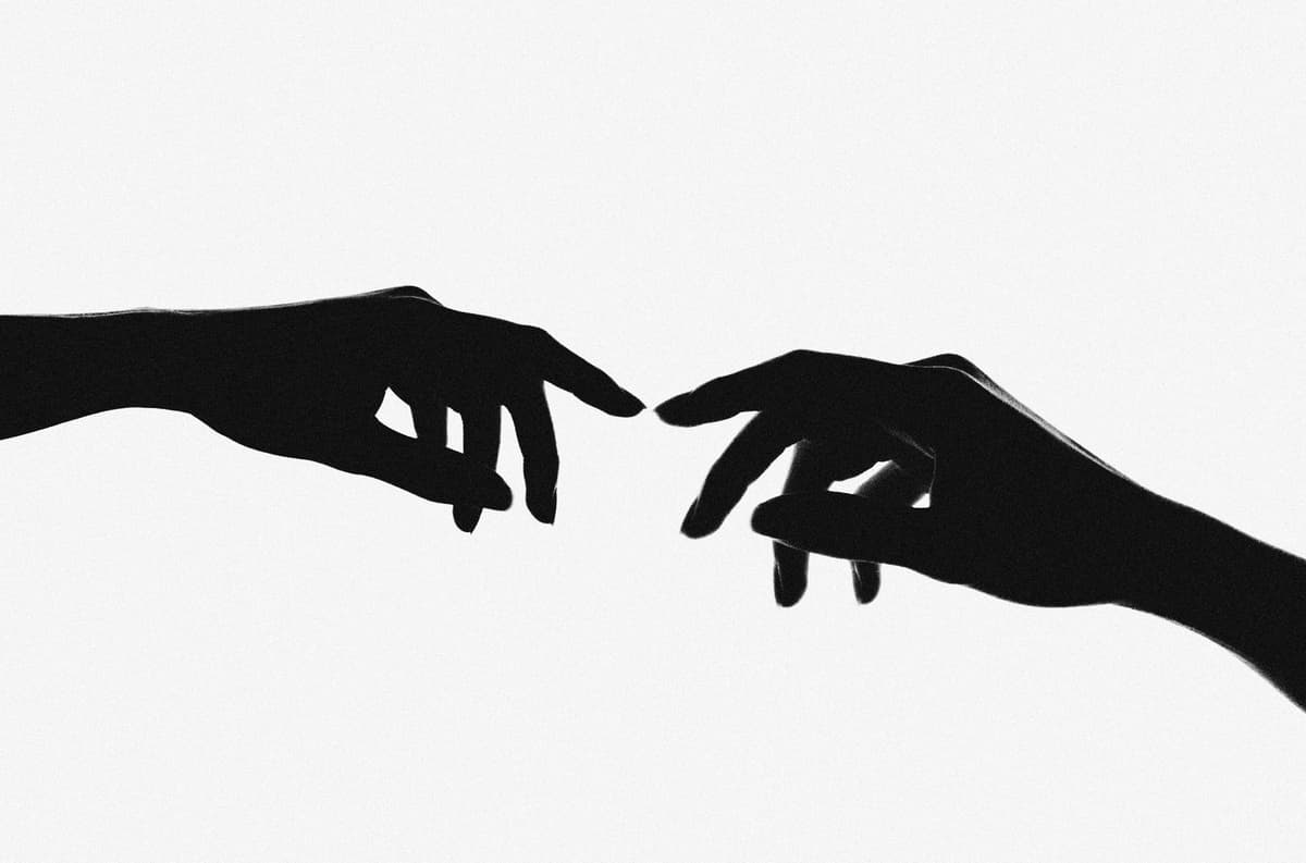Two hands reaching toward each other